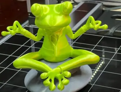 3D printed green yoga frog sculpture on Snapmaker 3D printer - origin story of 3D printing with toy frog.